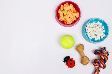 Pet accessories, food and toy on white background. Flat lay. Top view.