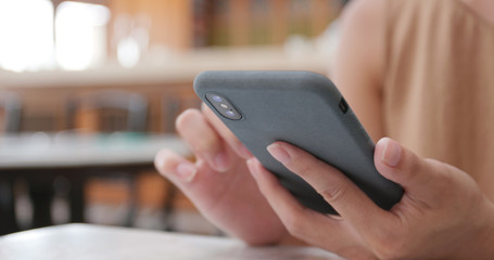 Woman use of cellphone in cafe