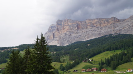Fototapeta na wymiar Houses sprawled in the valley of the mountains of the Italian Alps