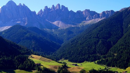 Houses sprawled in the valley of the mountains of the Italian Alps