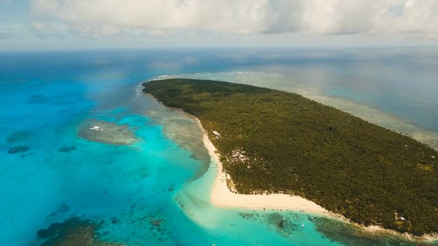 Aerial view of beautiful tropical island Daco with white sand beach. View of a nice tropical beach from the air. Beautiful sky, sea, resort. Seascape: Ocean and beautiful beach paradise. Philippines