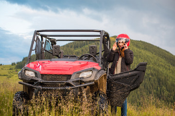 Nice view around mountains of young woman driving a quad bike on a sunny evening. Woman going on a nature zip line adventure, Europe or America  © T.Den_Team