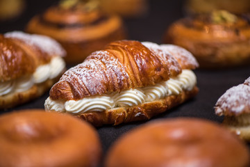 Cream croissant on dark background