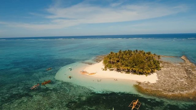 Aerial view of beautiful tropical island Guyam with white sand beach. View of a nice tropical beach from the air. Seascape: Ocean and beautiful beach paradise. Philippines. 4K video. Travel concept
