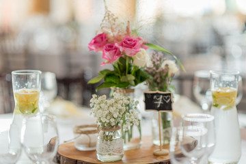 wedding table set up decoration with flowers and glasses