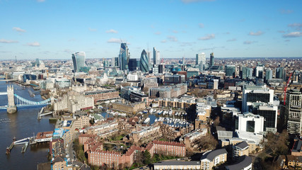 Obraz premium Aerial drone bird's eye view of iconic skyline in City of London as seen from St Katharine Docks Marina, London, United Kingdom