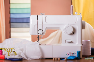 Sewing machine and fabric in work, near sewing accessories
