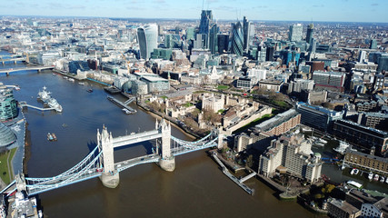 Aerial drone bird's eye view of iconic Tower Bridge, the Shard and skyline in City of London, United Kingdom
