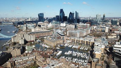 Fototapeta na wymiar Aerial drone bird's eye view of iconic skyline in City of London as seen from St Katharine Docks Marina, London, United Kingdom