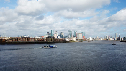 Naklejka premium Aerial bird's eye view photo taken by drone of famous Docklands and Canary Wharf skyscraper complex, Isle of Dogs, London, United Kingdom