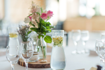 wedding table set up decoration with flowers and glasses