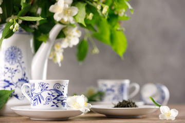 Obraz na płótnie Canvas A magnificent forfor tea set with a fragrant green tea. Green tea with a taste of jasmine.