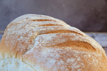 Loaf of bread on wooden board