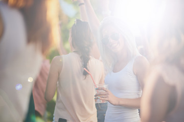 Group of people dancing and having a good time at the outdoor party/music festival 