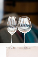 Two empty wine glasses with blurred background