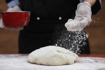 the cook makes flour for baking on the table