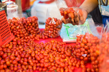 The pile of cherry tomatoes for sale at fresh market. Cherry tomatoes are a versatile favorite, a flavorful addition to salads, roasted veggie dishes, and more.