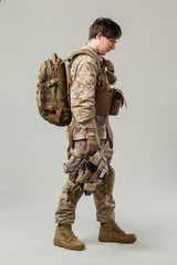 Soldier in camouflage holding rifle