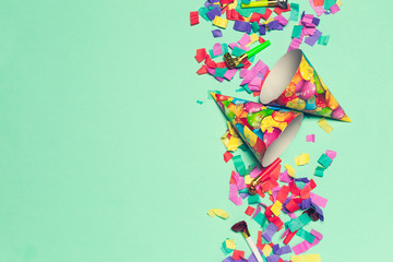 festive party decor and confetti on colored background