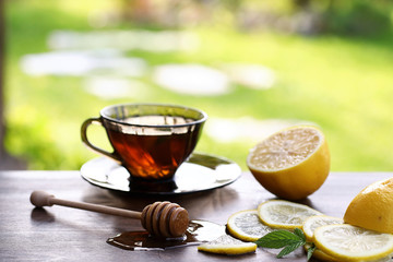 Fresh honey with a cup of black tea