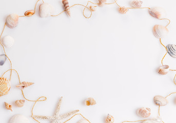 Romantic composition of exotic seashells, oyster, starfish on white background. Tropical summer vacation or Birthday, Wedding Day concept. Flat lay, top view. Marine design.