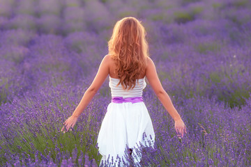 Fototapeta na wymiar Young woman in lavender field