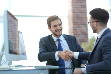 two young bearded men, handshake and smiling during the meeting