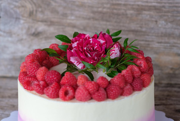 homemade cake with raspberries and a red rose