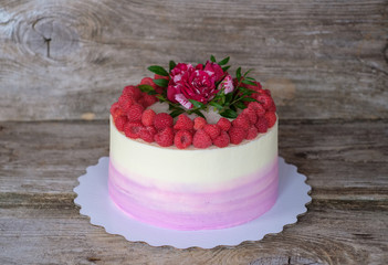homemade cake with raspberries and a red rose