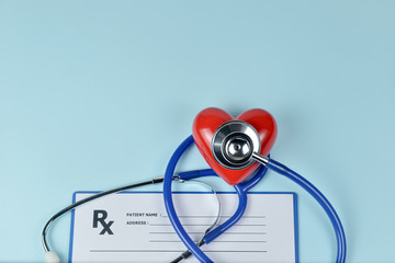Stethoscope, red heart and prescription on blue background, Heart Check.Concept healthcare.