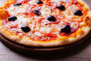 Classical pizza with ham and black olives, appetizing snack with lots of meat. Italian recipe, tasty mediterranean cuisine food concept