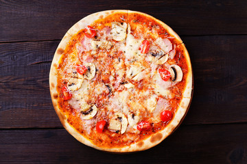 Pizza with cherry tomatoes, ham and mushrooms, traditional Italian recipe, delicious mediterranean meals. Food delivery, restaurant, pizzeria menu concept