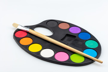 paintbrushes palette and watercolor paints