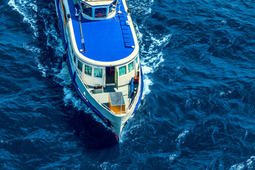 Top view of a cruise boat in the blue sea