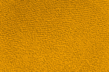 Beautiful sea background - yellow sandy bottom with ripples in clear sea water, top view