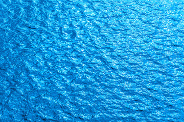 Beautiful sea background - blue water surface with small ripples, top view