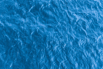 Fototapeta Beautiful sea background - blue water surface with small ripples, top view obraz