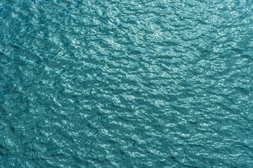 Beautiful sea background - blue water surface with small ripples, top view