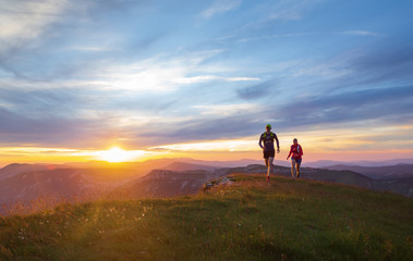 Two athletes trail running in Massif du Vercors during sunset. Shallow D.O.F.