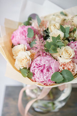 beautiful summer bouquet. flower arrangement with peonies. Color light pink. The concept of a flower shop.