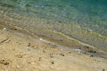 beach at summer time - blue waves and yellow sand