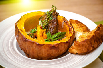beautiful flow in the restaurant, baked pumpkin with beans and meat, beautiful food closeup