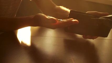 A man with indignation throwing an empty purse on the table