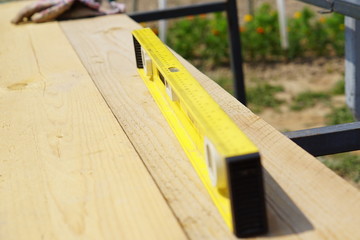 Yellow building level . working tool on wooden background