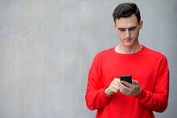 Young handsome man using phone