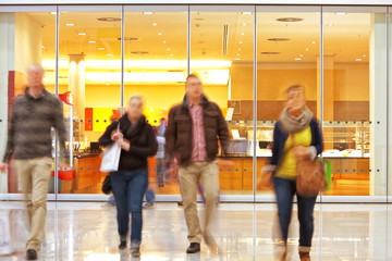 Motion Blurred People Against Shop