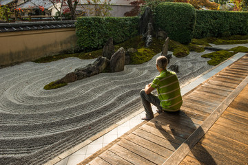 Man is relaxing in a Zen garden in Japan