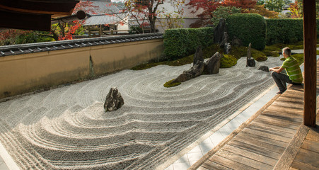 Man is relaxing in a Zen garden in Japan