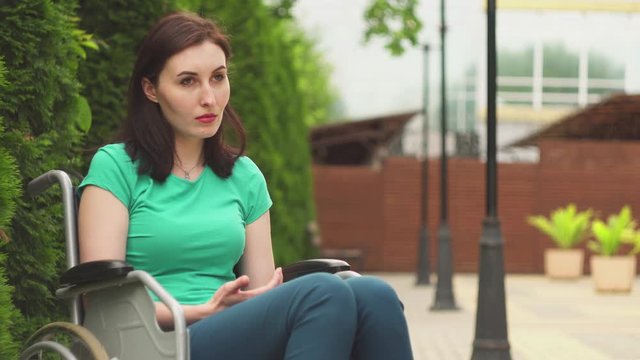 Portrait attractive sad girl with disabilities sitting in a wheelchair , concept