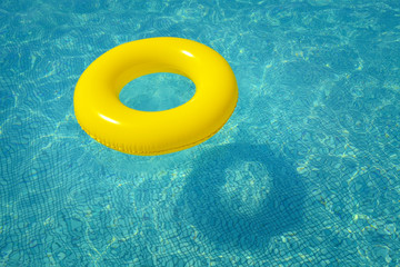 Colorful inflatable tube floating in swimming pool